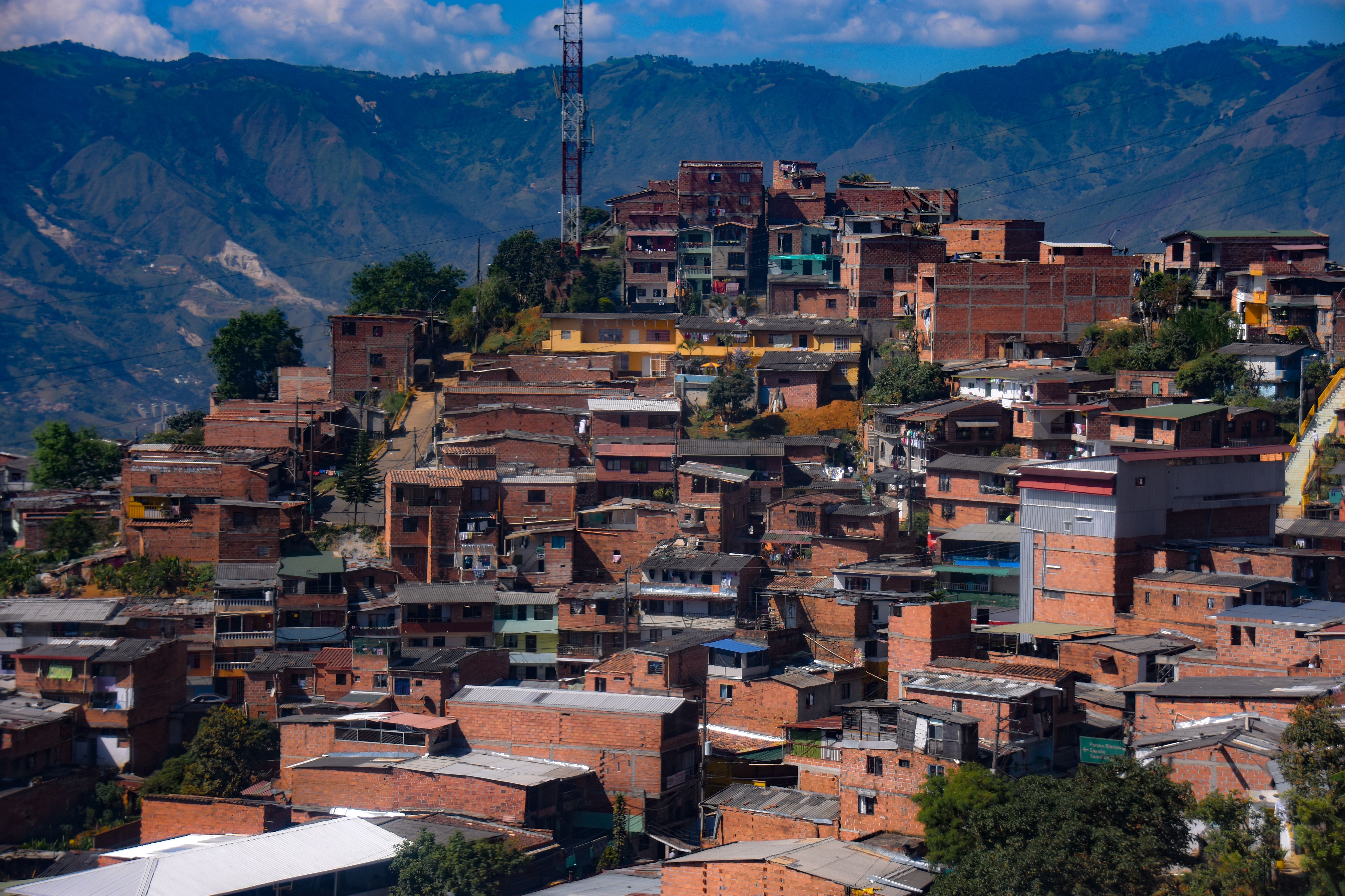 Colorful hillside neighborhood set against mountains in Medellin, Colombia