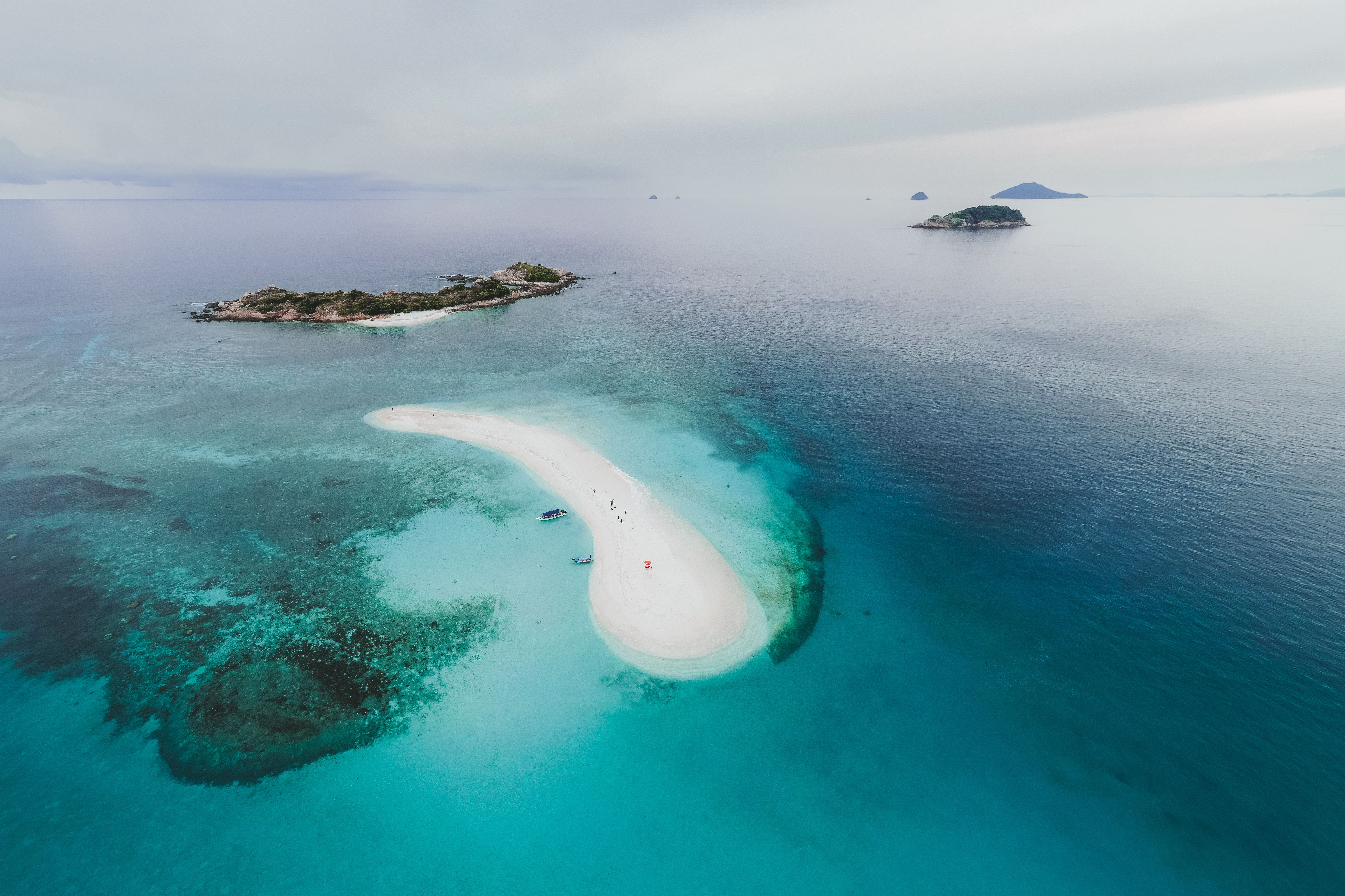 Aerial view of tropical islands and a sandbar surrounded by clear blue water
